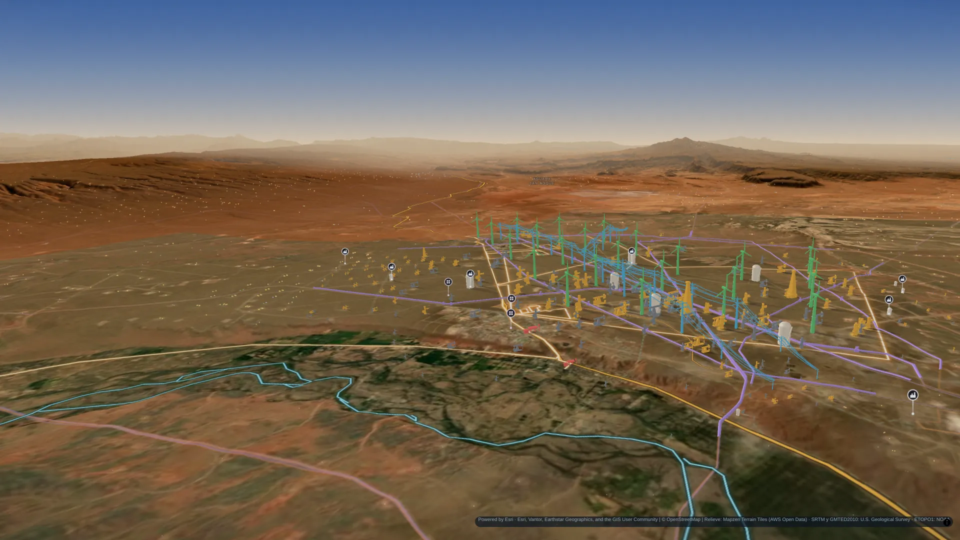 Añelo y el río Neuquén vistos desde el aire en el mapa 3D: pozos, tanques, ductos y líneas de alta tensión sobre el relieve real